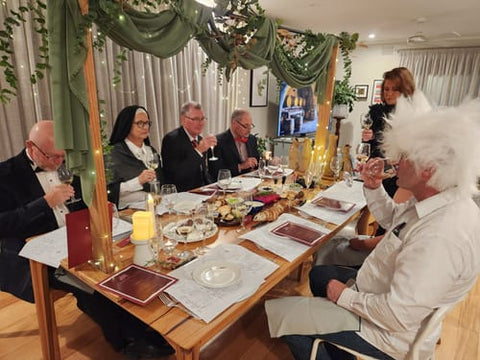 Costumed guests around a decorated dinner table playing the wine tasting murder mystery — verified Loox review photo