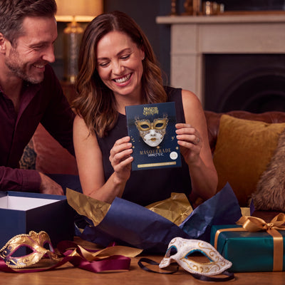 Masquerade Ball Murder Mystery Game boxed game being given as a gift – 1x1 lifestyle image