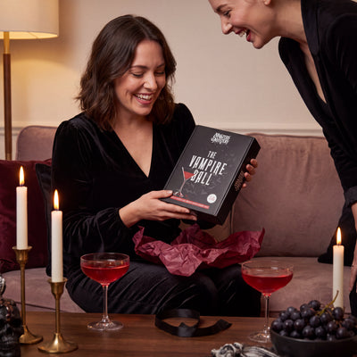 Vampire Ball Murder Mystery Game boxed game being given as a gift – 1x1 lifestyle image